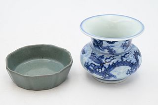 Two Chinese Porcelain Pieces
to include a small shallow celadon dish in fitted wood box
diameter 4 1/4 inches;
along with a blue and white five claw d