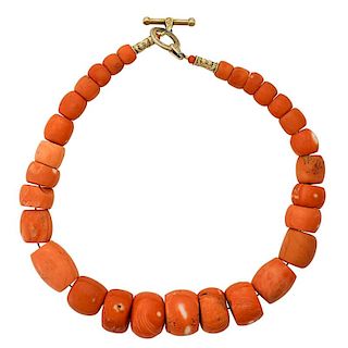 STRAND OF BARREL OR DRUM SHAPED CORAL BEADS