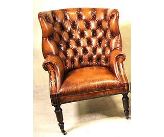 LEATHER BUTTON-TUFTED WING CHAIR.