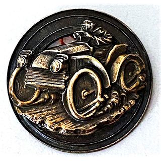 A SCARCE EXAMPLE OF "BARNEY OLDFIELD" BRASS BUTTON