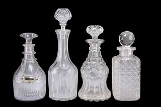 A GROUP OF FOUR GEORGIAN AND LATER GLASS DECANTERS, one with silver-plated 