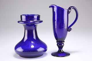 AN EARLY 19TH CENTURY BRISTOL BLUE GLASS JUG AND BULB VASE, the tall cream 