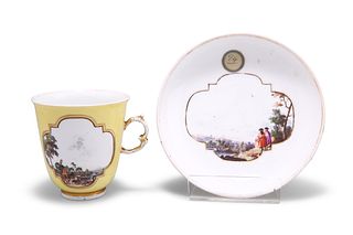 AN 18TH CENTURY MEISSEN YELLOW GROUND CUP AND SAUCER, the cup painted with 