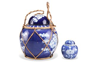A CHINESE BLUE AND WHITE GINGER JAR AND COVER, decorated with prunus, 14cm 
