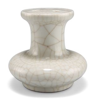 A CHINESE CELADON VASE, of squat form, the enclosed top with three pierced 