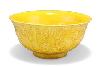 A CHINESE YELLOW-GLAZED BOWL, flared circular, moulded with dragons, lustro