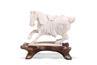 A CHINESE IVORY CARVING OF A HORSE, 19TH CENTURY, on a hardwood stand. 8cm 