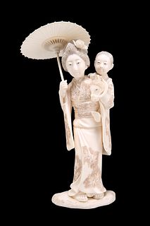 A JAPANESE MEIJI PERIOD CARVED IVORY OKIMONO, depicting a woman in traditio