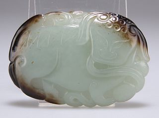 A CHINESE JADE BELT BUCKLE, oval, carved with a shishi, the stone of celado