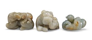 THREE CHINESE JADE CARVINGS, comprising Buddhistic lion, boy with cat, and 