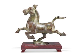 AFTER THE ANTIQUE, A CHINESE BRONZE OF A PRANCING HORSE, with green verdigr