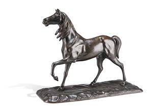 A PATINATED BRONZE MODEL OF A HORSE, cast with a foreleg raised, standing o