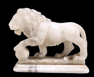 A 19TH CENTURY ALABASTER CARVING OF A MEDICI LION, its left paw resting on 