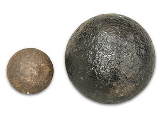 TWO ANTIQUE IRON CANNON BALLS, the larger painted black. (2) Largest approx