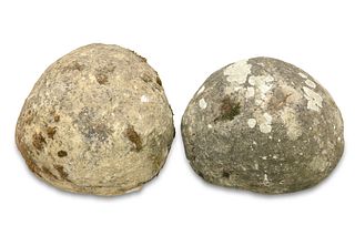 TWO WEATHERED STONE BALUSTER TREBUCHET PROJECTILES, later used as finials. 