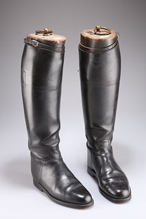 A PAIR OF LEATHER RIDING BOOTS, black leather with full length zips, wooden