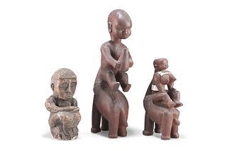 THREE TRIBAL CARVED FIGURES, two wooden, each depicted on the back of an el