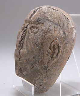 A CARVED STONE HEAD, SOUTH AMERICAN, possibly pre-Columbian, the small flat