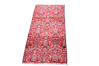 AN IRANIAN CARPET, the rich red ground with all-over scrolling foliate and 