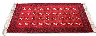 AN IRANIAN HAND-KNOTTED WOOL CARPET, BALOCHISTAN, the bright red field with