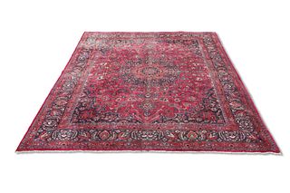 A LARGE PERSIAN MASHAD CARPET, the raspberry field with all-over scrolling 