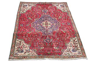 A PERSIAN TABRIZ CARPET, the red field with all-over scrolling foliate desi