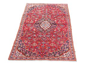 A PERSIAN KASHAN CARPET, the bright red field with all-over scrolling folia