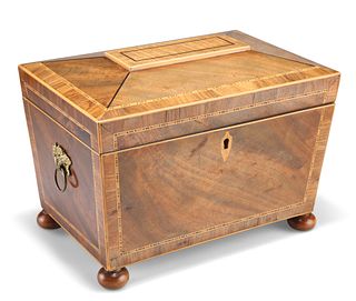 A REGENCY INLAID MAHOGANY TEA CADDY, of sarcophagus form, the interior with
