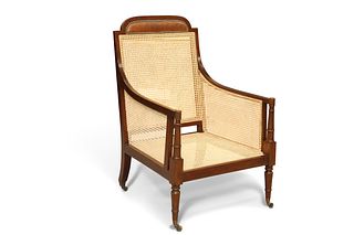 AN EDWARDIAN MAHOGANY AND CANEWORK BERGÈRE, IN GEORGE III STYLE, the crest 