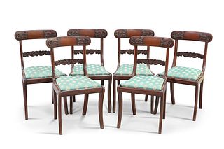A SET OF SIX REGENCY ROSEWOOD DINING CHAIRS, each with scroll carved splat 