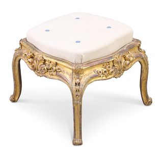 A 19TH CENTURY CARVED AND GILDED STOOL, of square serpentine outline, raise