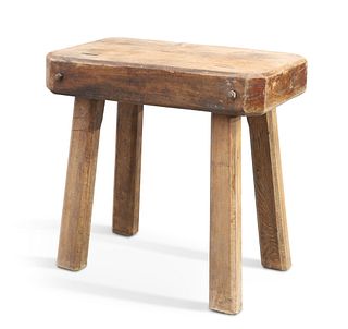 AN ELM BUTCHERS BLOCK, the rectangular top with canted corners, raised on c