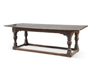 A 17TH CENTURY OAK REFECTORY TABLE, the enclosed plank-top raised on block 