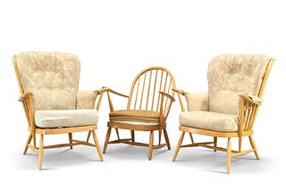 THREE VINTAGE ERCOL LOUNGE CHAIRS, each with spindle back and splayed legs.