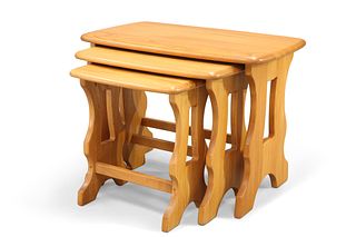 A NEST OF THREE ERCOL TABLES, with trestle ends. (3) Largest 42cm high, 56.