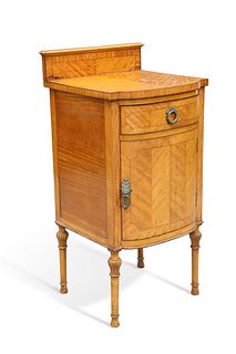 A SATINWOOD POT CUPBOARD, bow-fronted, the crossbanded and half-veneered to
