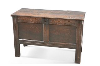 A 17TH CENTURY OAK COFFER, with carved rail above a two-panel front. 68cm h