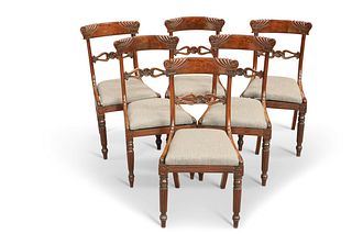 A SET OF SIX REGENCY MAHOGANY DINING CHAIRS, each with partially gadrooned 