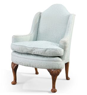 AN EARLY 20TH CENTURY WALNUT AND UPHOLSTERED WING-BACK ARMCHAIR, with bow f