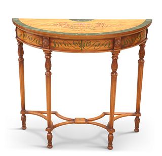 A NEOCLASSICAL STYLE DEMILUNE CONSOLE TABLE, decorated with ribbon-tied swa