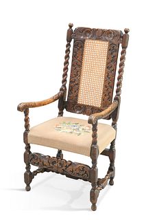 A CAROLEAN STYLE OAK OPEN ARMCHAIR, 19TH CENTURY, the back carved with scro
