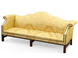 A GEORGE III STYLE MAHOGANY AND UPHOLSTERED SETTEE, with out-scrolled arms 