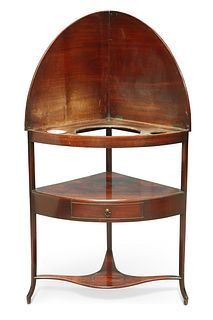 A GEORGE III MAHOGANY CORNER WASHSTAND, bow-fronted, fitted with a drawer a
