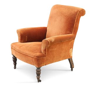A VICTORIAN OAK AND UPHOLSTERED ARMCHAIR, raised on reeded cup and cover fo