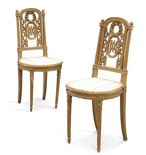 A PAIR OF VICTORIAN GILT SIDE CHAIRS, each open work back with a laurel wre