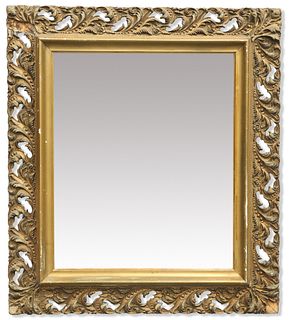 A VICTORIAN GILT-COMPOSITION MIRROR, the rectangular mirror plate within a 