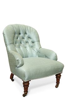 A VICTORIAN MAHOGANY AND DEEP BUTTONED COUNTRY HOUSE ARMCHAIR, raised on tu