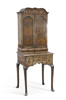 A WALNUT CABINET ON STAND, the upper section with a pair of short drawers a