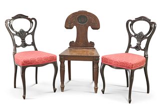 A REGENCY MAHOGANY HALL CHAIR, the unusually shaped back with painted crest