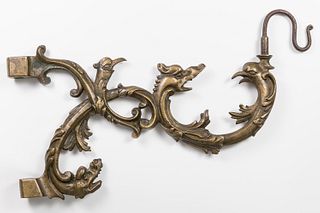 Arm with grotesques for wall lamp; Holland, XVII century. Bronze and iron.